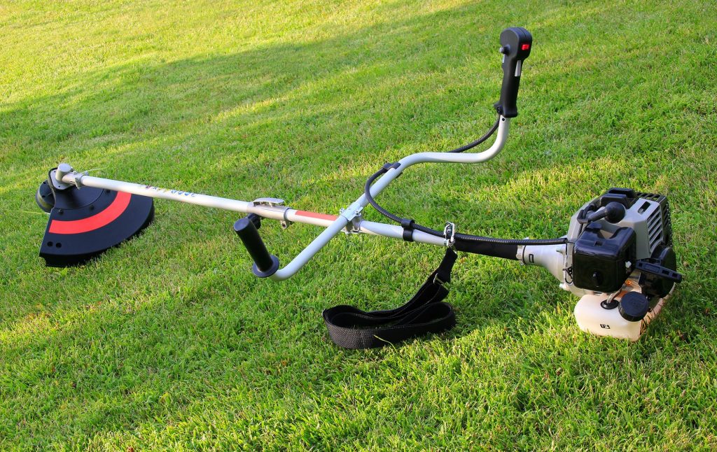 Petrol strimmer on a lawn.