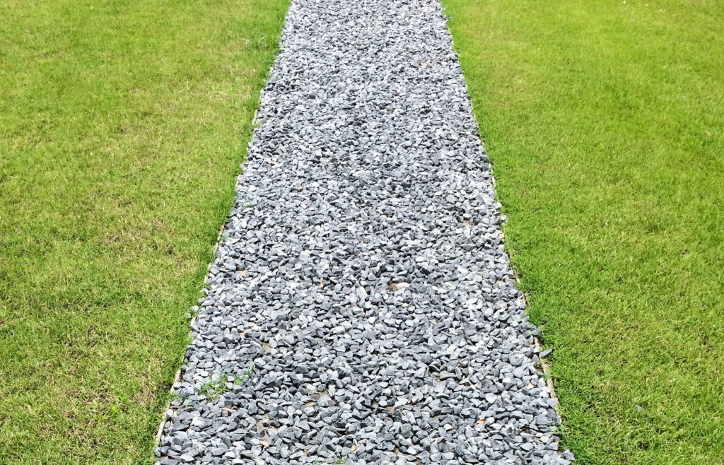 Crushed rock gravel path on a lawn.