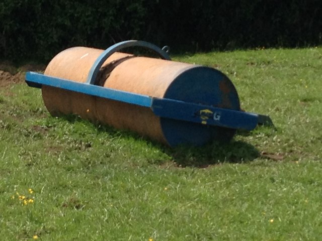 Lawn roller on some grass.