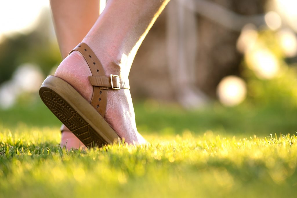 Woman walking on a lawn.