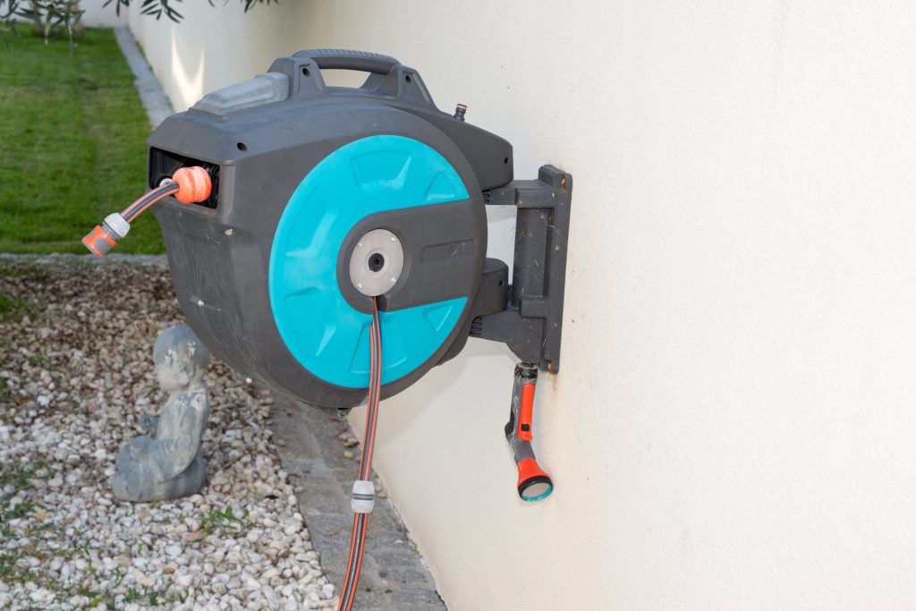 Wall mounted garden hose reel.